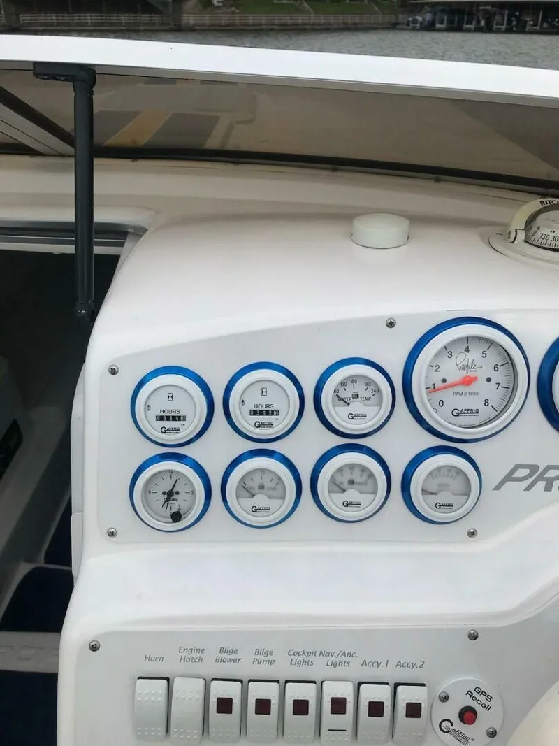 Slide: The Image of Dashboard of a 2002 Profile 33 V boat with various gauges and switches. - 17