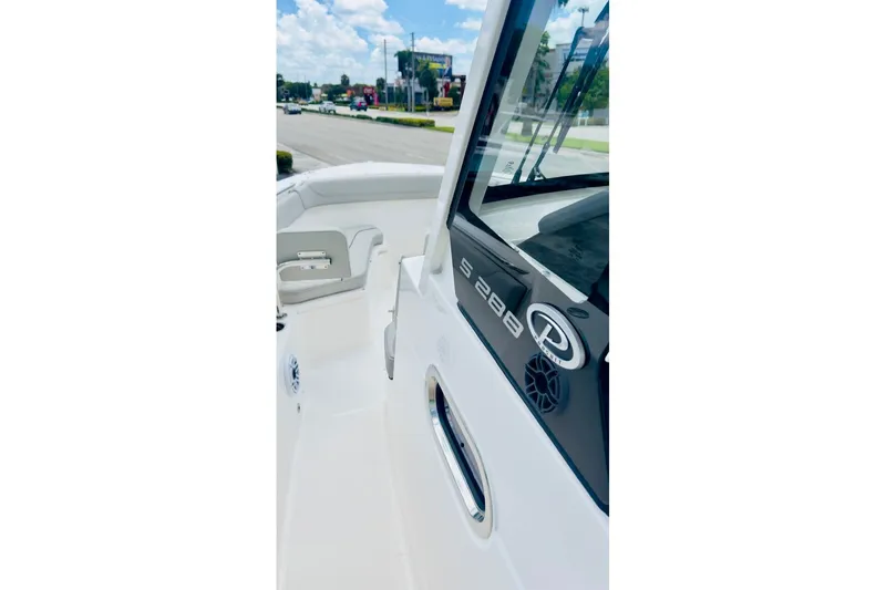 Slide: The Image of 2026 Pursuit S 288 Sport boat, sleek design with modern features, docked outdoors. - 10