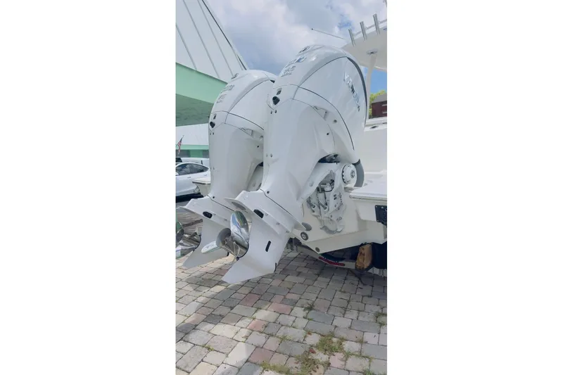 Slide: The Image of 2026 Pursuit S 288 Sport boat with dual outboard engines on display. - 13