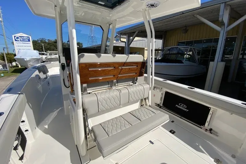 Slide: The Image of 2026 Pursuit S 288 Sport boat interior with cushioned seating and sleek design. - 4