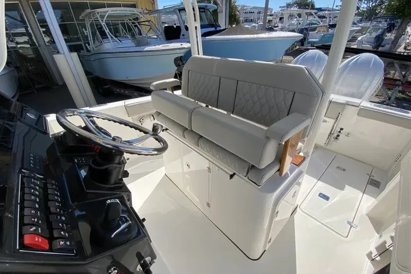 Slide: The Image of 2026 Pursuit S 288 Sport boat interior with steering wheel and cushioned seating. - 2