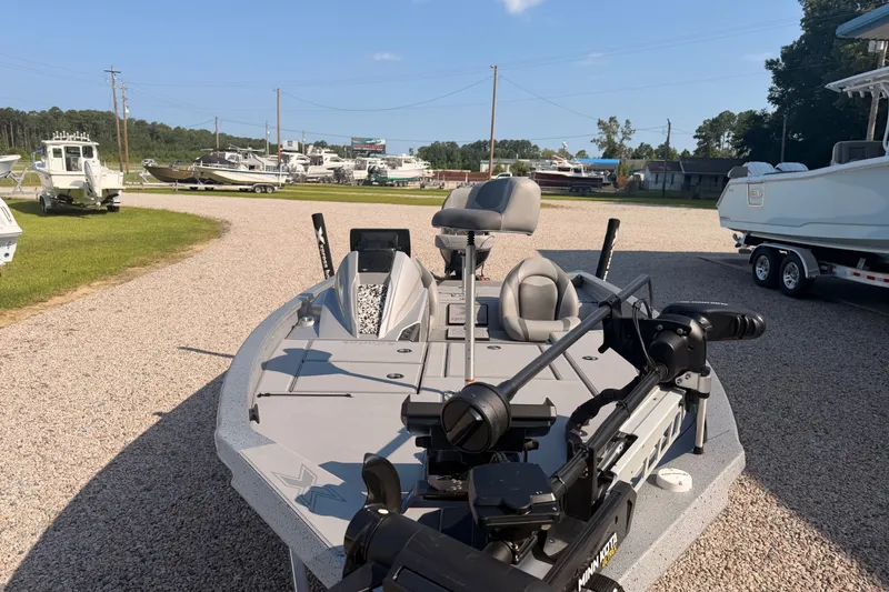 Slide: The Image of 2023 Xpress Boats H18 Bass boat in a marina, featuring modern design and equipment. - 3