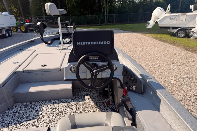 Slide: The Image of 2023 Xpress Boats H18 Bass interior with steering wheel and Humminbird electronics. - 7