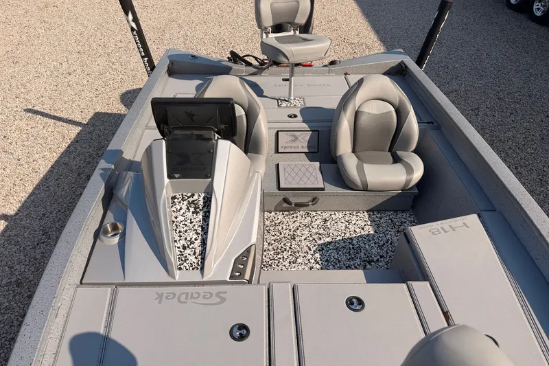 Slide: The Image of 2023 Xpress Boats H18 Bass interior with gray seating and modern dashboard design. - 6