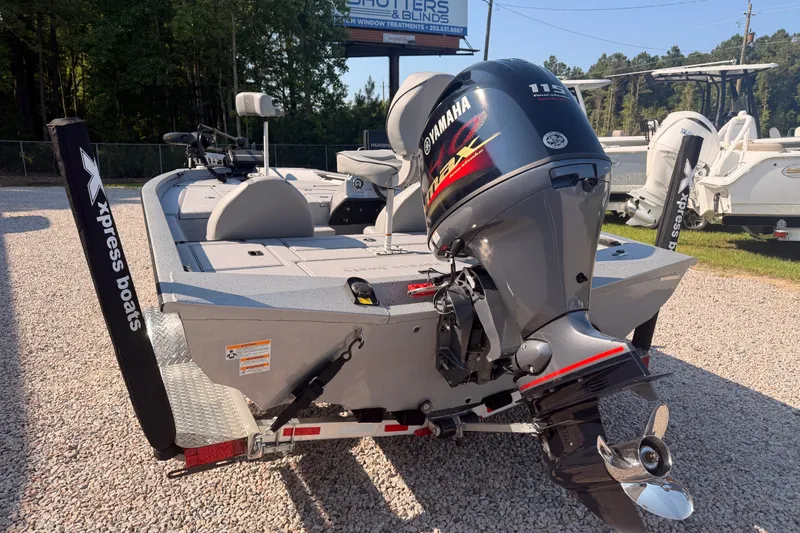 Slide: The Image of 2023 Xpress Boats H18 Bass with Yamaha engine, parked on gravel lot. - 4