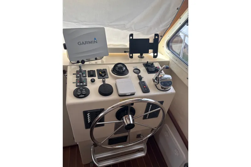 Slide: The Image of Helm of 2018 Eastern 35 Casco Bay boat with Garmin navigation system and controls. - 15