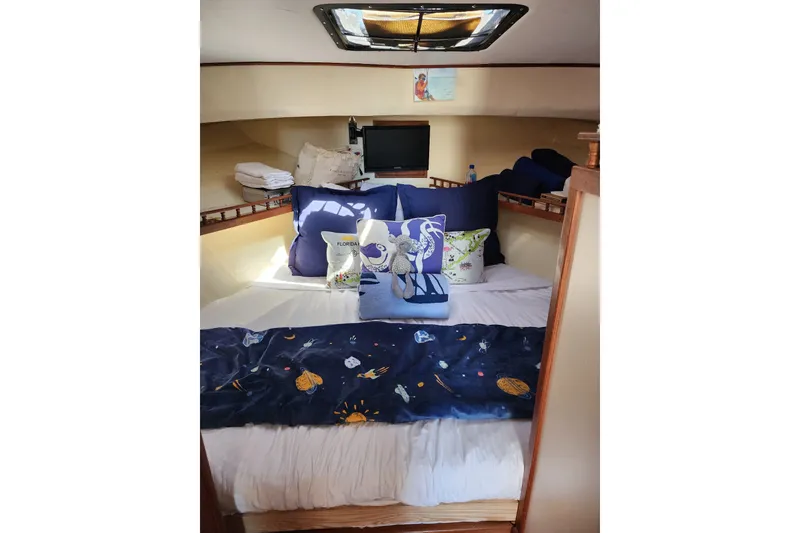 Slide: The Image of Cozy cabin interior of 2018 Eastern 35 Casco Bay boat with nautical-themed bedding. - 21