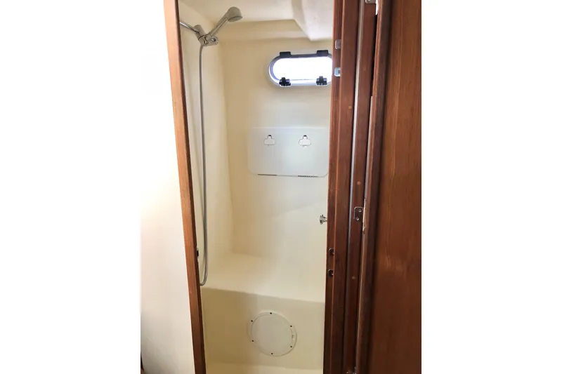 Slide: The Image of Shower area inside 2018 Eastern 35 Casco Bay boat, featuring wooden door and compact design. - 23