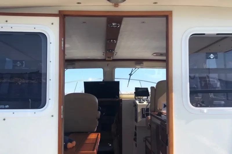 Slide: The Image of Interior view of 2018 Eastern 35 Casco Bay boat, showcasing helm and seating area. - 12