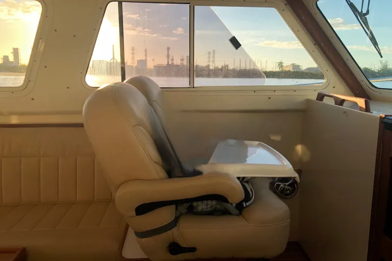 Slide: The Image of Interior of 2018 Eastern 35 Casco Bay boat with beige seating and window view. - 18