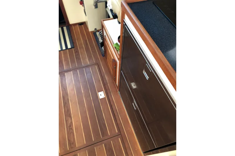Slide: The Image of Interior of 2018 Eastern 35 Casco Bay boat with wooden flooring and cabinetry. - 17