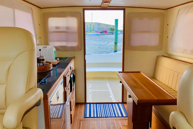 Slide: The Image of Interior of 2018 Eastern 35 Casco Bay boat with kitchen and seating area. - 11