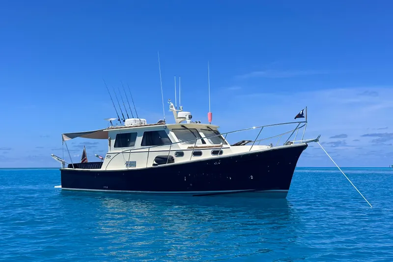 The Image of 2018 Eastern 35 Casco Bay boat anchored on clear blue water under a sunny sky. - 0