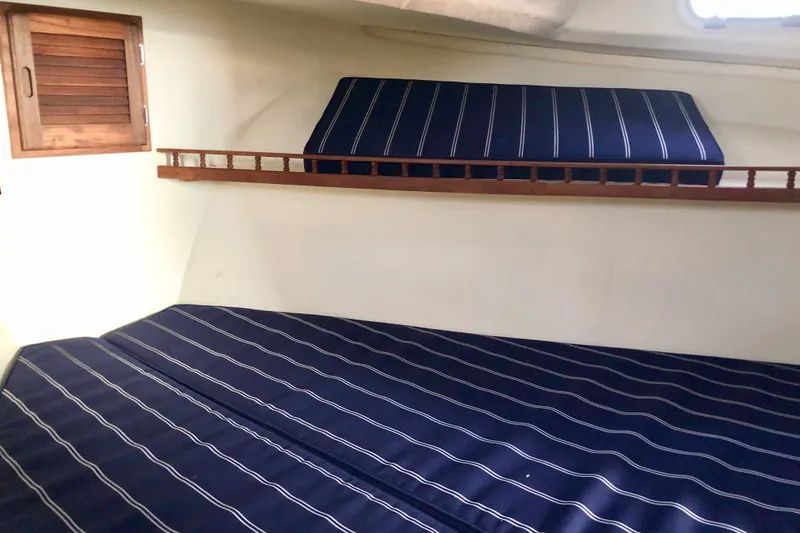 Slide: The Image of Interior cabin of 2018 Eastern 35 Casco Bay boat with striped blue cushions. - 22