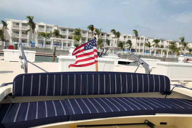 Slide: The Image of 2018 Eastern 35 Casco Bay boat with American flag, docked near waterfront buildings. - 9