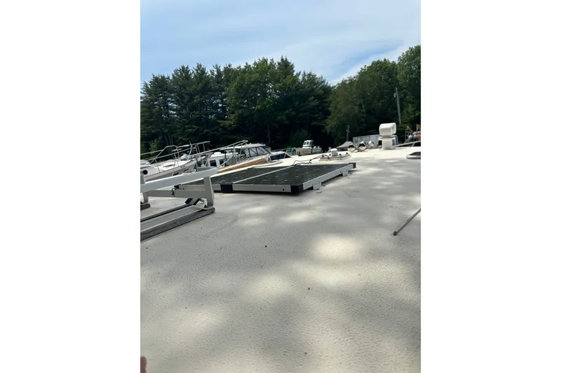 Slide: The Image of 2018 Eastern 35 Casco Bay boat deck with trees and other boats in the background. - 29
