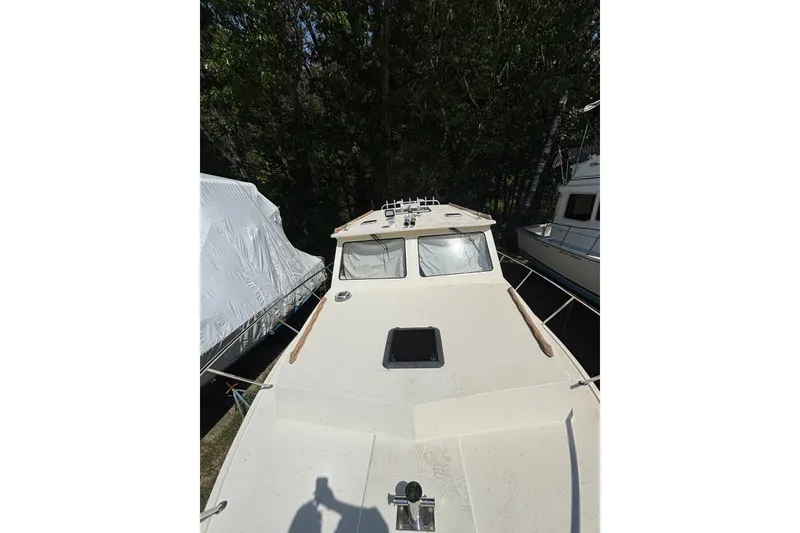 Slide: The Image of 2018 Eastern 35 Casco Bay boat docked among trees and other vessels. - 35