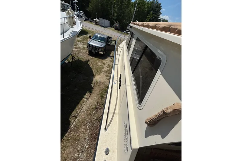 Slide: The Image of 2018 Eastern 35 Casco Bay boat on land, with nearby parked truck. - 33