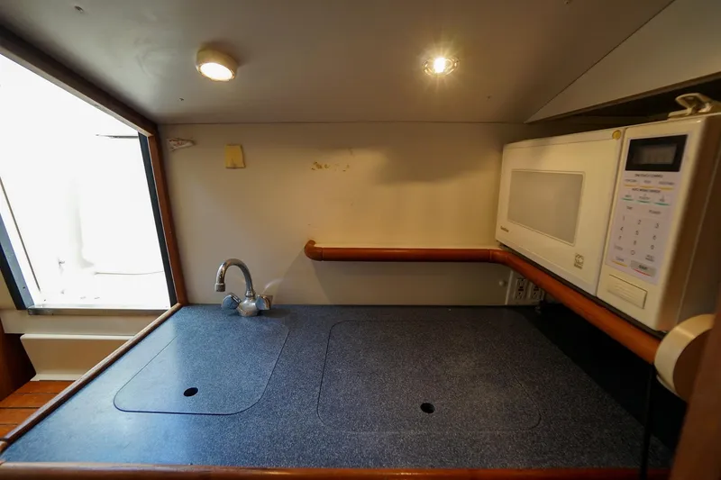 Slide: The Image of 1997 Tiara Yachts 3500 Express galley with sink and microwave. - 48