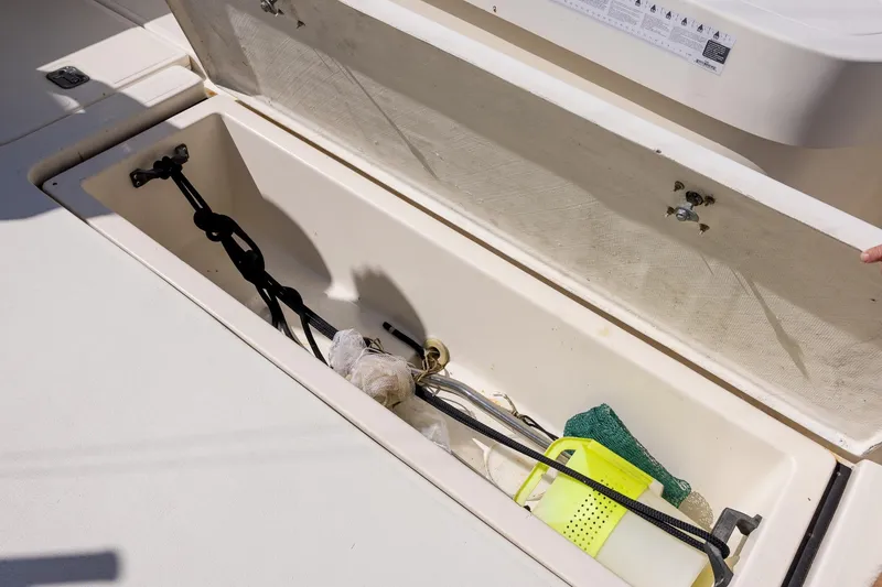 Slide: The Image of Storage compartment on a 1997 Tiara Yachts 3500 Express, containing various boating accessories. - 25