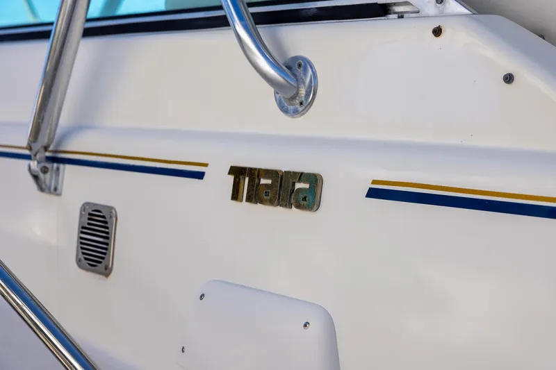 Slide: The Image of 1997 Tiara Yachts 3500 Express boat detail with logo and railing. - 35