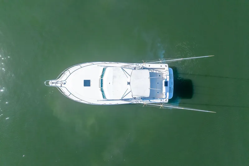 Slide: The Image of Overhead view of 1997 Tiara Yachts 3500 Express on calm green water. - 8