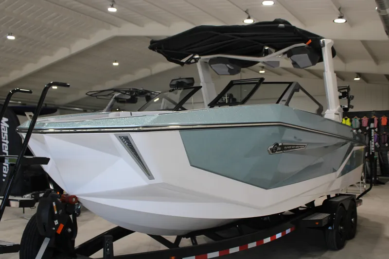Slide: The Image of 2026 Nautique Super Air Nautique G25 boat displayed indoors on a trailer. - 5