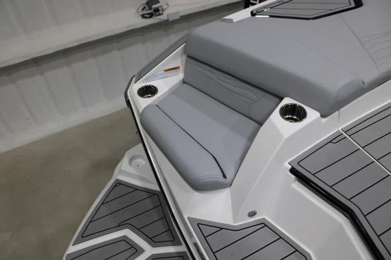 Slide: The Image of 2026 Nautique Super Air Nautique G25 boat interior with gray seating and cup holders. - 6