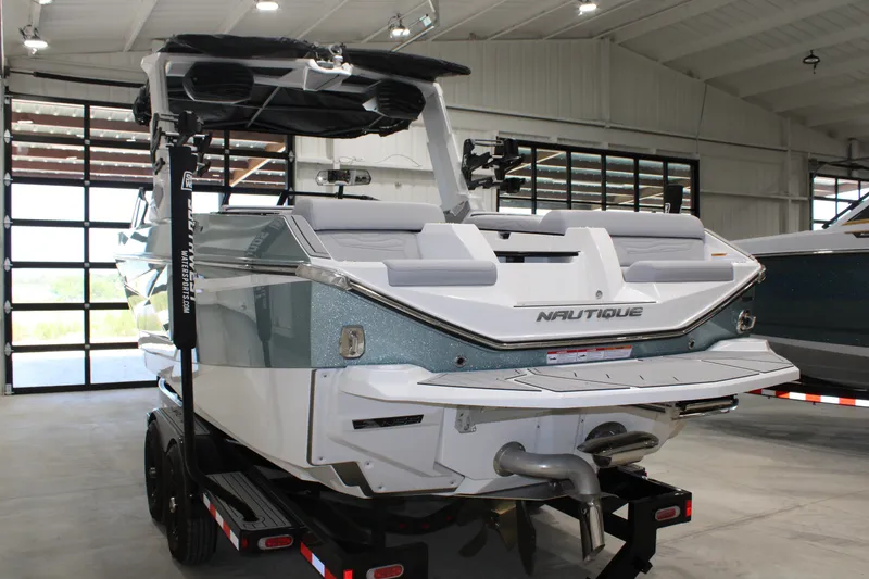 Slide: The Image of 2026 Nautique Super Air Nautique G25 boat in showroom, rear view. - 4