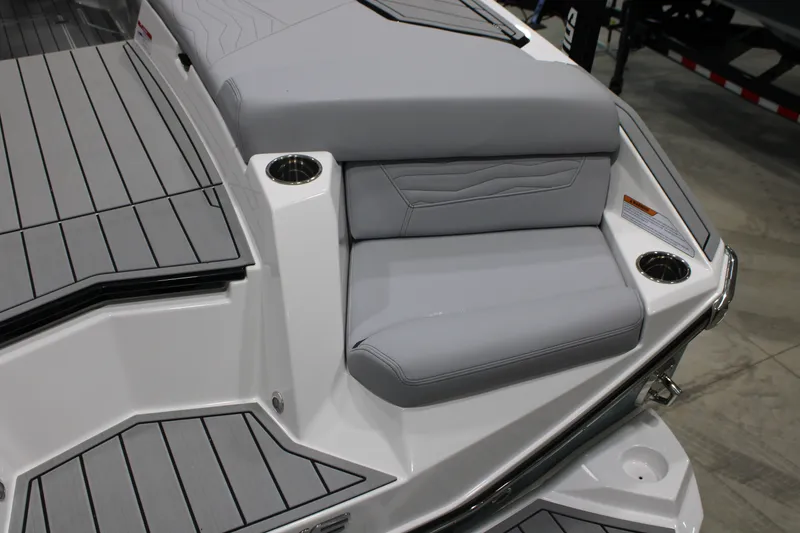 Slide: The Image of 2026 Nautique Super Air Nautique G25 boat interior with gray seating and cup holders. - 8