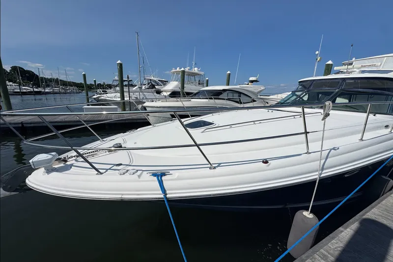 Slide: The Image of 2006 Sea Ray 44 Sundancer yacht docked at marina under clear blue sky. - 4