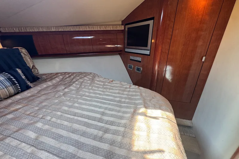 Slide: The Image of Luxurious cabin interior of 2006 Sea Ray 44 Sundancer with wood paneling and TV. - 25