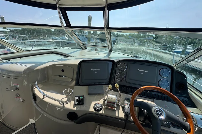 Slide: The Image of Helm of 2006 Sea Ray 44 Sundancer with Raymarine displays and wooden steering wheel. - 15