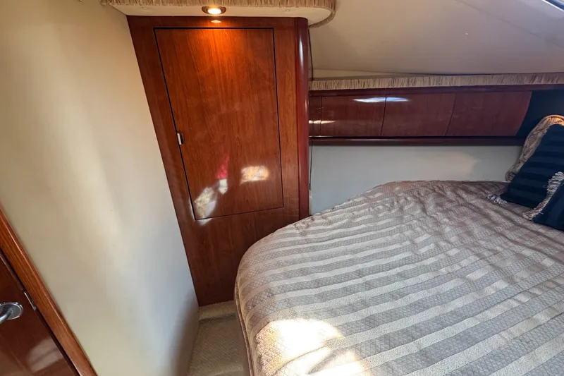 Slide: The Image of Luxurious cabin interior of 2006 Sea Ray 44 Sundancer yacht with wood paneling. - 26