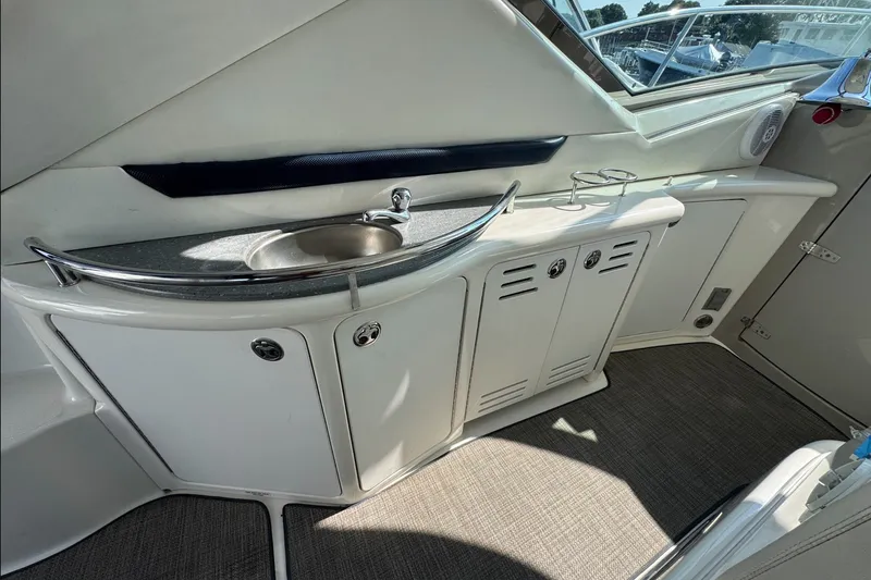 Slide: The Image of 2006 Sea Ray 44 Sundancer yacht interior with sink and storage cabinets. - 10