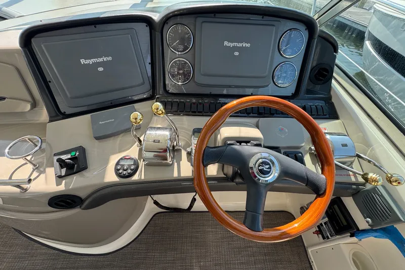 Slide: The Image of Helm of 2006 Sea Ray 44 Sundancer with Raymarine navigation system and wooden steering wheel. - 16