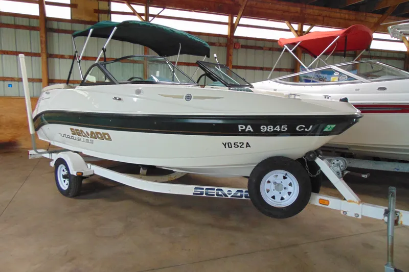 The Image of 2001 Sea-Doo Utopia 185 boat on trailer in indoor storage facility. - 0