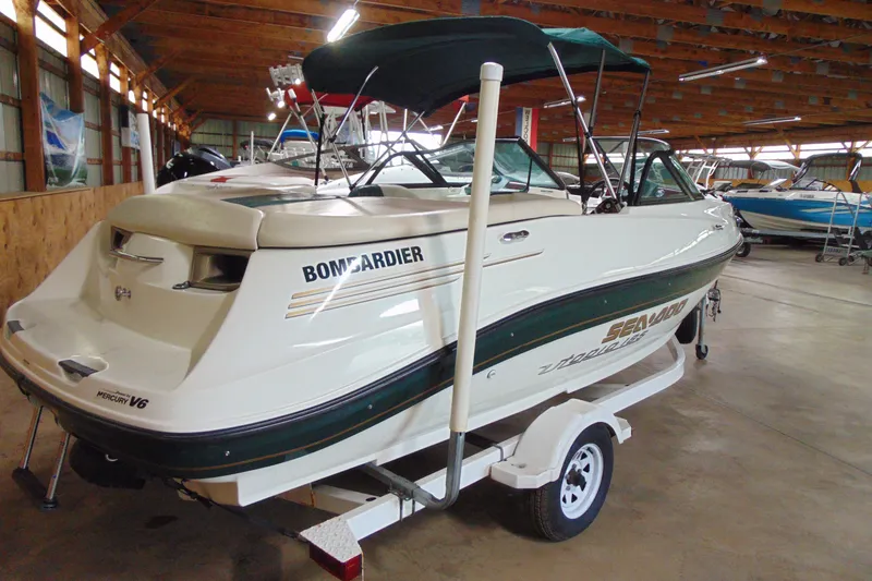 Slide: The Image of 2001 Sea-Doo Utopia 185 boat in storage, featuring a Mercury V6 engine. - 3