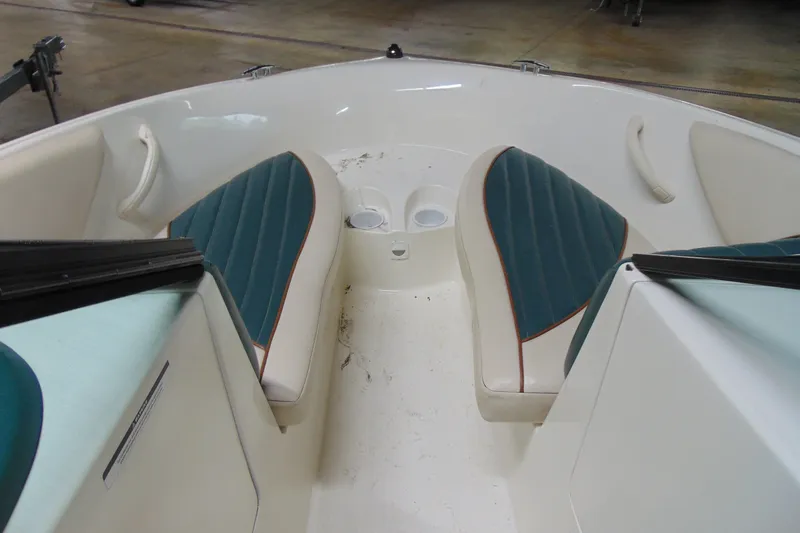Slide: The Image of 2001 Sea-Doo Utopia 185 boat interior with teal seats and cup holders. - 10