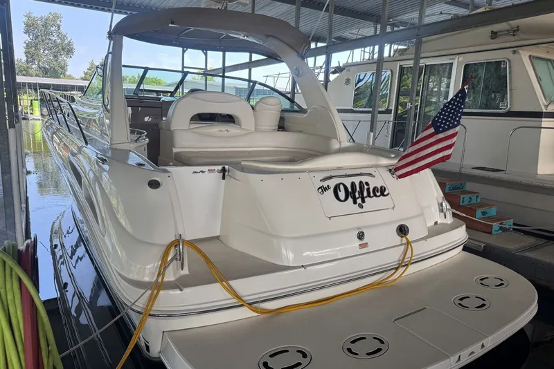 Slide: The Image of 2003 Sea Ray 410 Sundancer docked, displaying "The Office" name and American flag. - 13