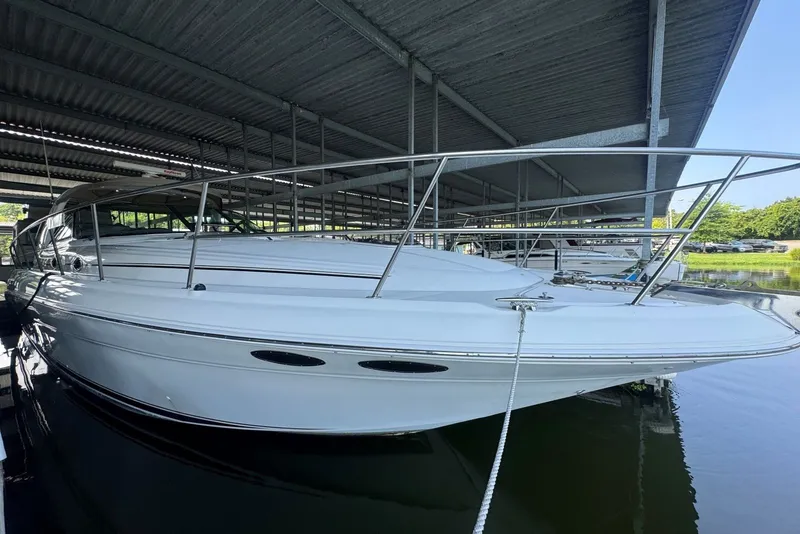 Slide: The Image of 2003 Sea Ray 410 Sundancer yacht docked under a covered marina. - 9