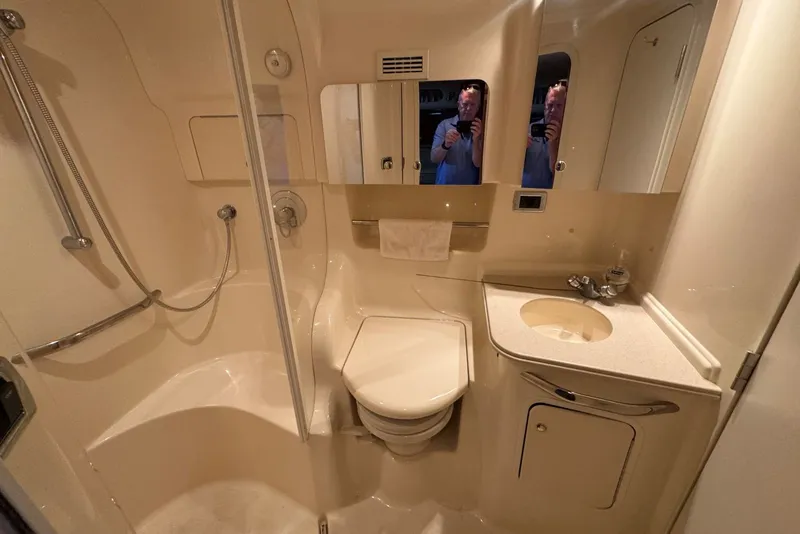 Slide: The Image of Bathroom interior of 2003 Sea Ray 410 Sundancer yacht, featuring shower, toilet, and sink. - 44