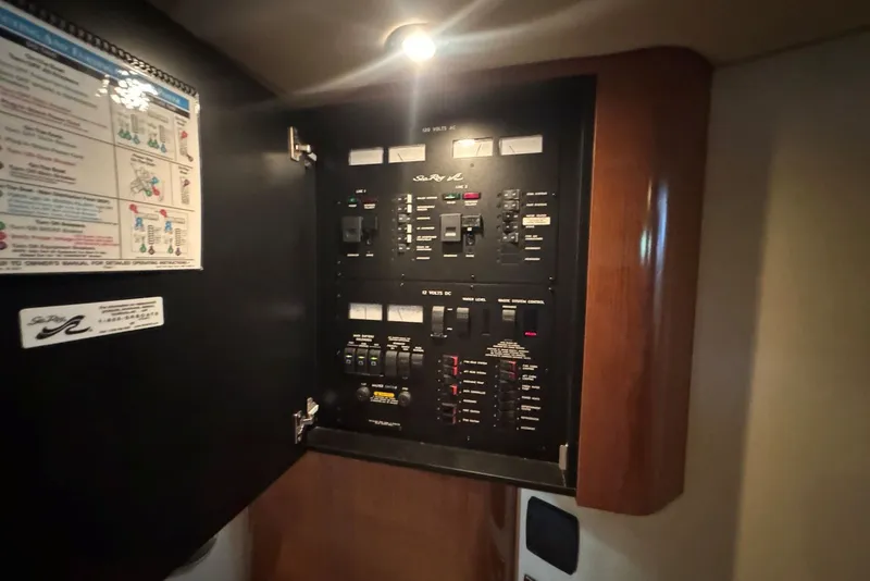 Slide: The Image of Electrical panel inside a 2003 Sea Ray 410 Sundancer yacht, illuminated and detailed. - 55