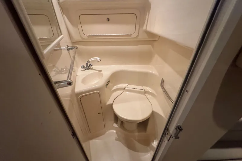 Slide: The Image of Bathroom interior of 2003 Sea Ray 410 Sundancer yacht, featuring sink and toilet. - 53