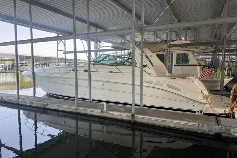 Slide: The Image of 2003 Sea Ray 410 Sundancer yacht docked in a covered marina slip. - 3