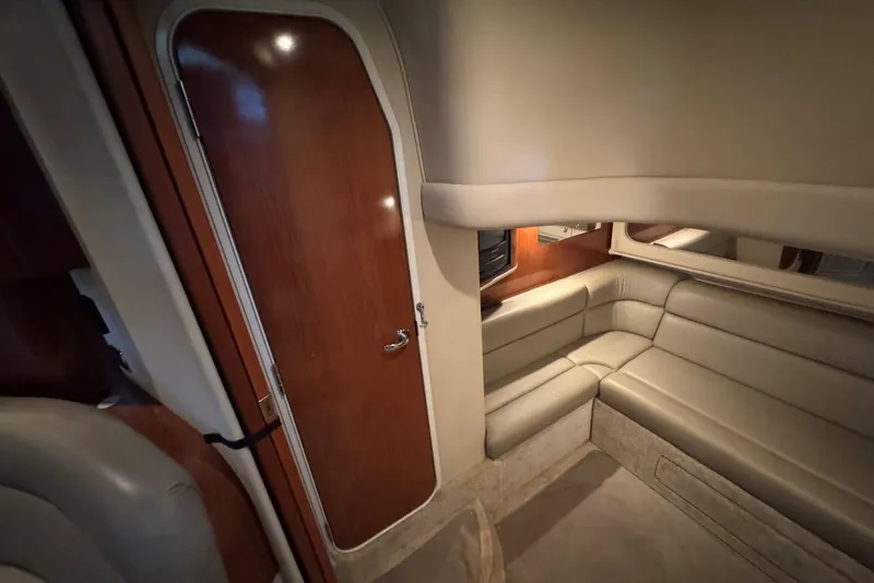 Slide: The Image of Interior of 2003 Sea Ray 410 Sundancer yacht with beige seating and wooden door. - 52