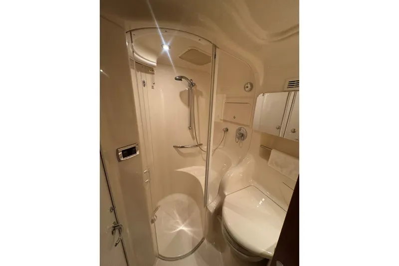 Slide: The Image of Bathroom interior of 2003 Sea Ray 410 Sundancer yacht, featuring shower and toilet. - 46