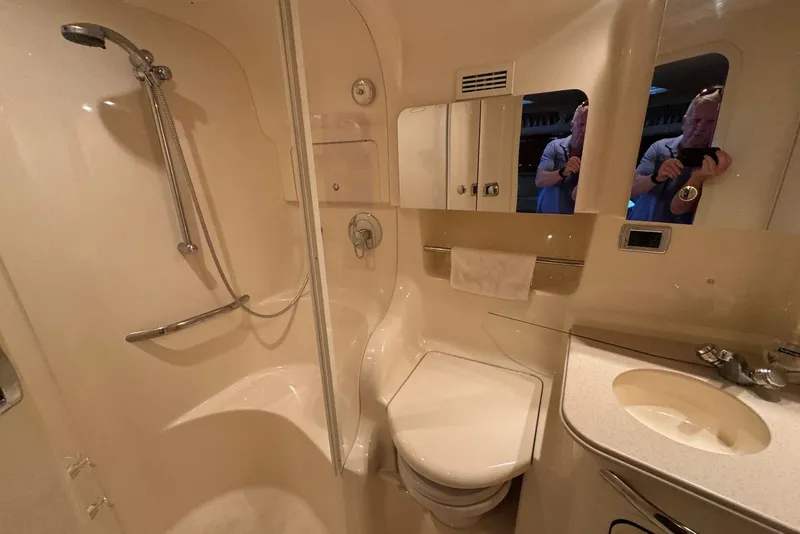 Slide: The Image of Bathroom interior of 2003 Sea Ray 410 Sundancer yacht, featuring shower, toilet, and sink. - 45