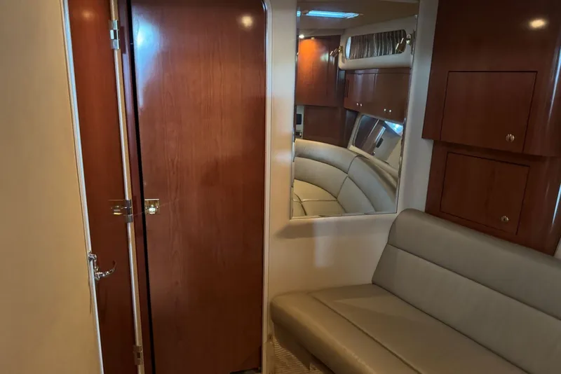 Slide: The Image of Interior of 2003 Sea Ray 410 Sundancer yacht with wood paneling and seating. - 48