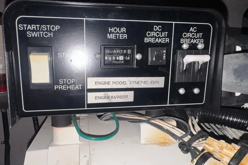 Slide: The Image of Control panel of a 2003 Sea Ray 410 Sundancer boat engine with hour meter and circuit breakers. - 62